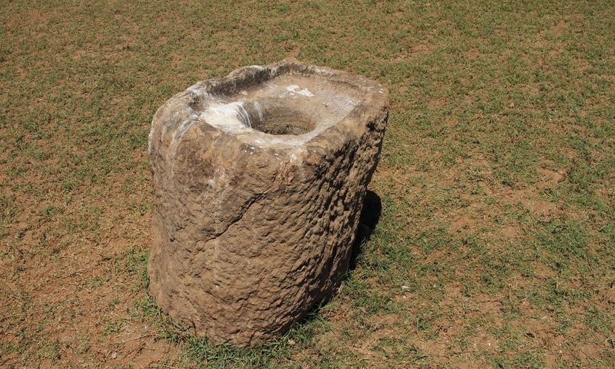 Large, weathered stone resembling an ancient mortar.