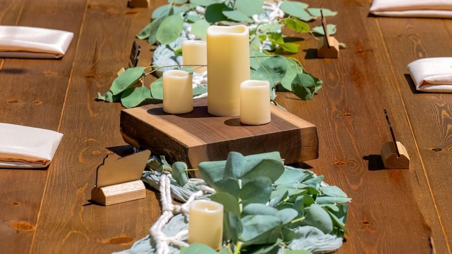 Top view of a decorated long dining table with candles and greenery at Kit Carson Lodge.