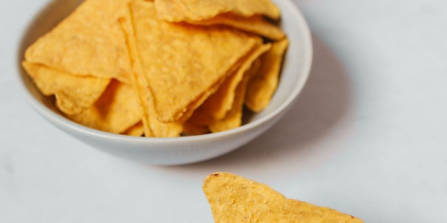 alt-text person eating nachos with cheese