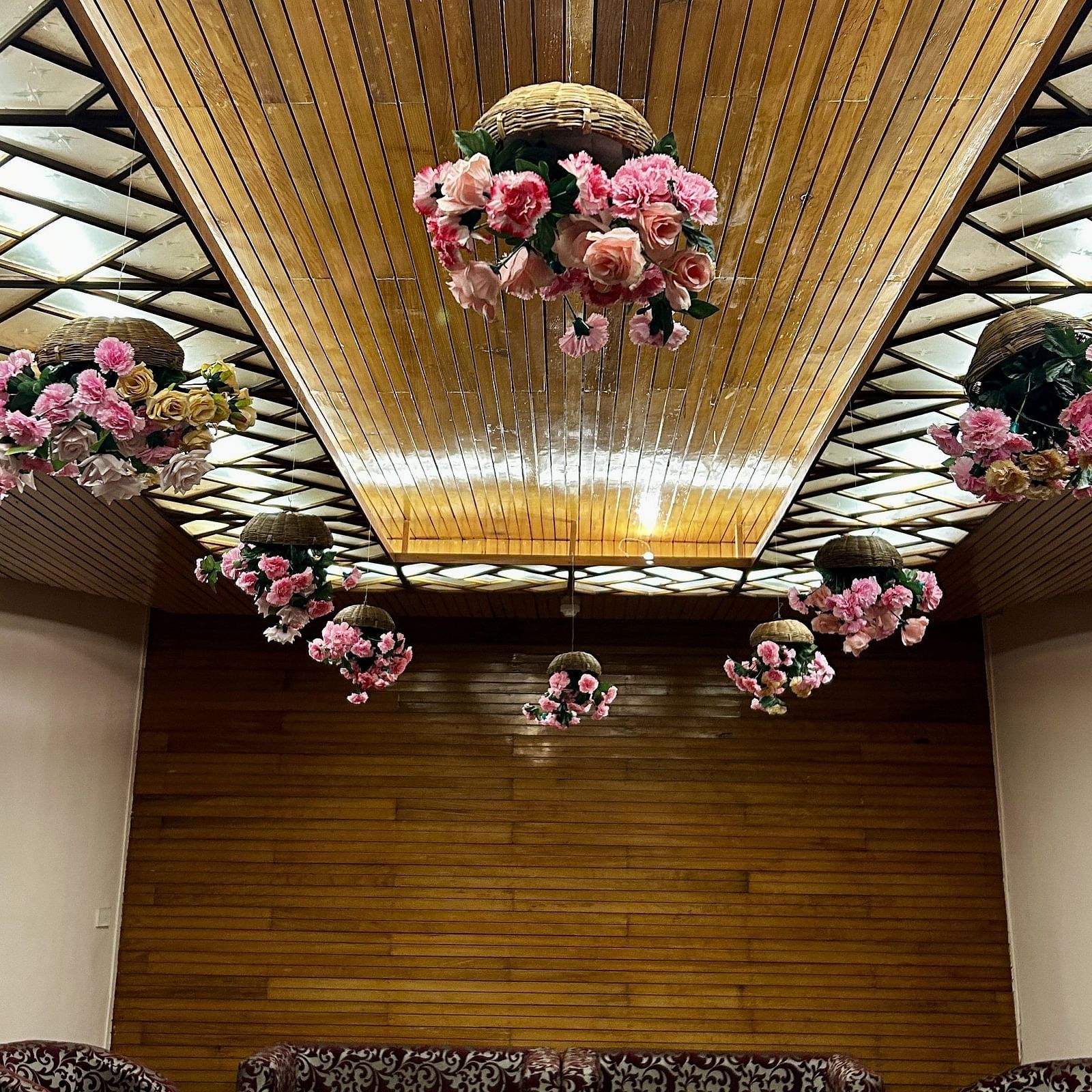 Indoor wedding setup at Cedar Inn, Darjeeling, featuring a decorated ceiling canopy and cosy seating area.