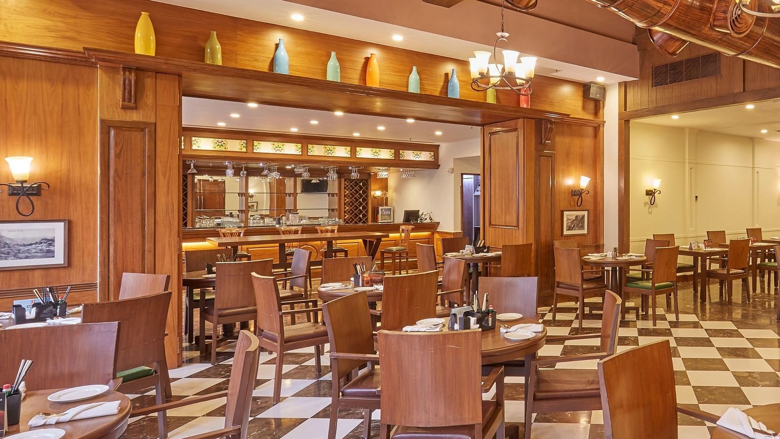 An overview of Cedar restaurant featuring wooden interiors and an elegant dining arrangement - Rhythm Lonavala