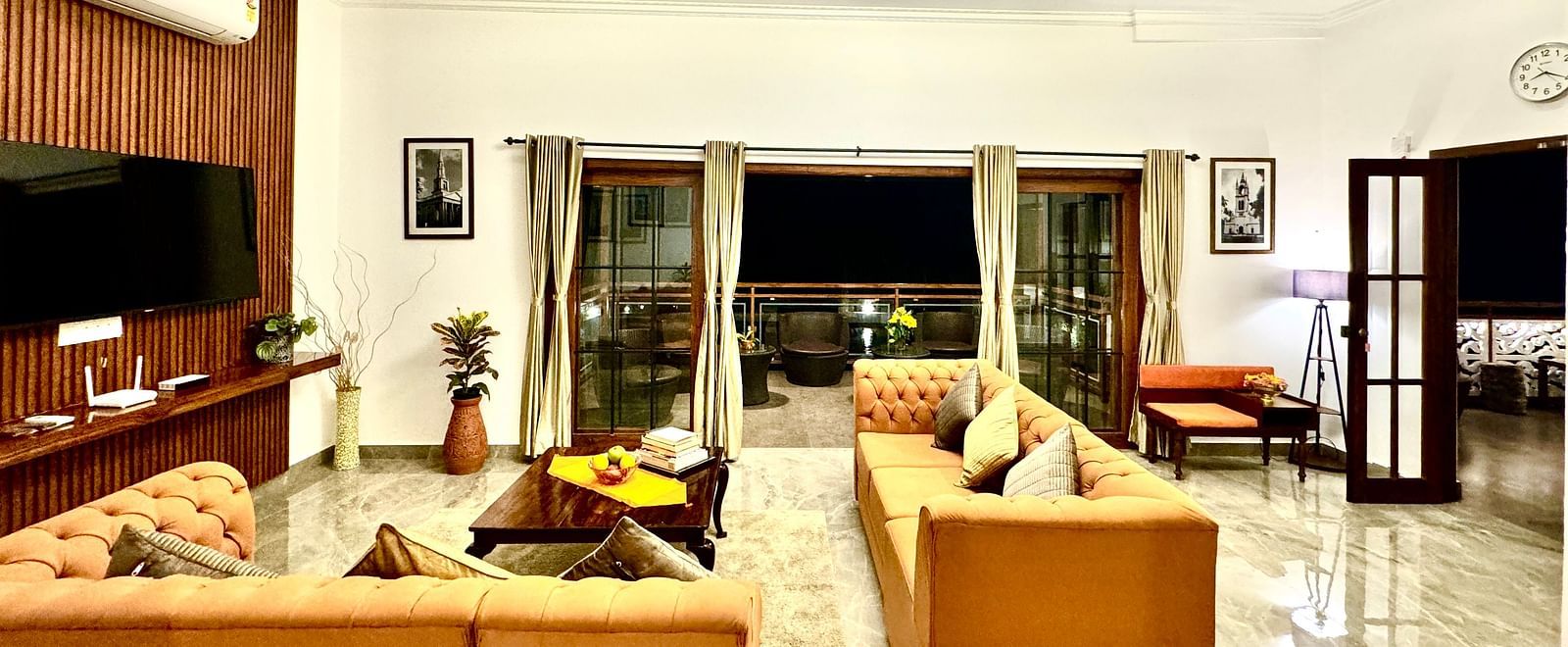Bright and airy villa interior with comfortable sofas and large glass doors to the outside - BluSalzz Collection - Tranquil Resort, Wayanad