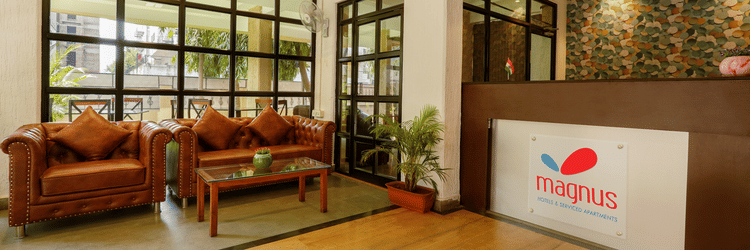 Image of a lobby featuring the seating area and large windows - Magnus Calypso Suites, Viman Nagar