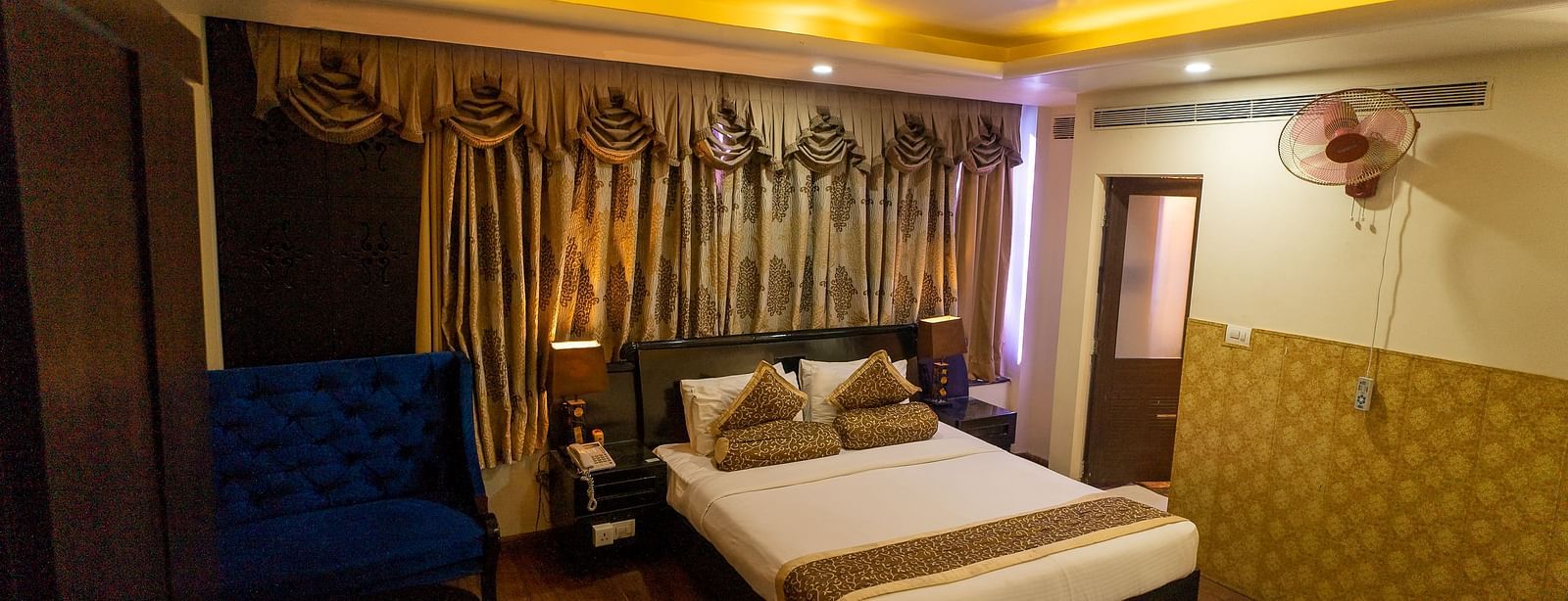 A large bed in a Deluxe Room at Hotel Ashok Nagpur.
