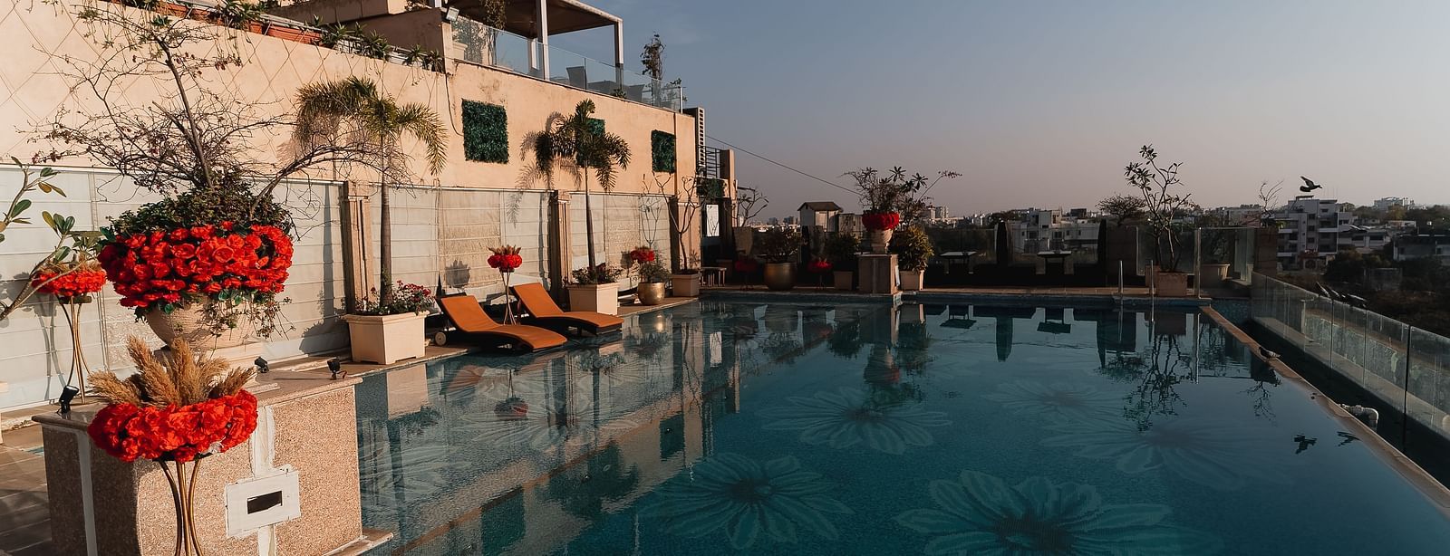 An outdoor swimming pool at Hotel Ashok Nagpur during the day.