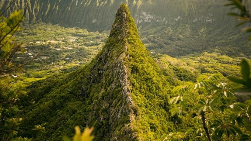 Image of a cliff filled with lush greenery and a mountain range in the background - The Dukes Retreat, Khandala