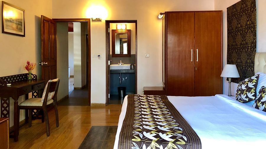 Room featuring a double bed a work desk, a wardrobe and a bathroom