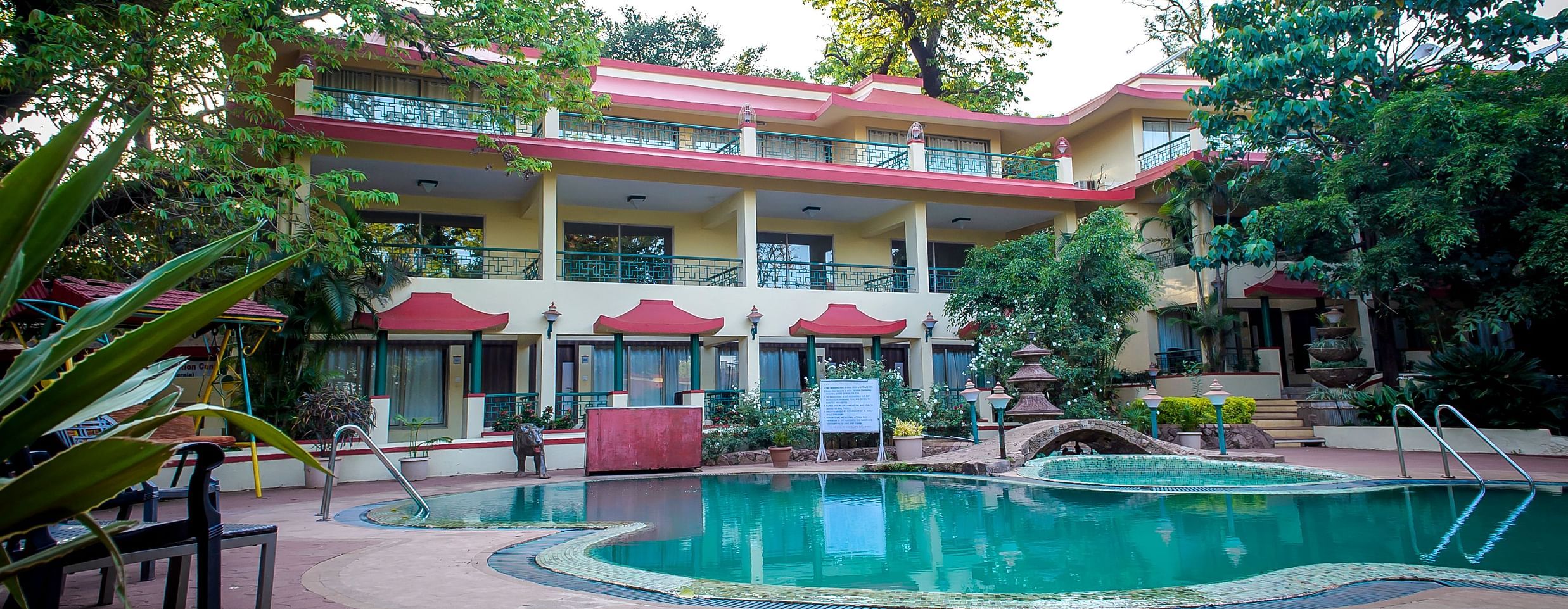 Picture of Pool with big building in the background - Adamo Resort Matheran