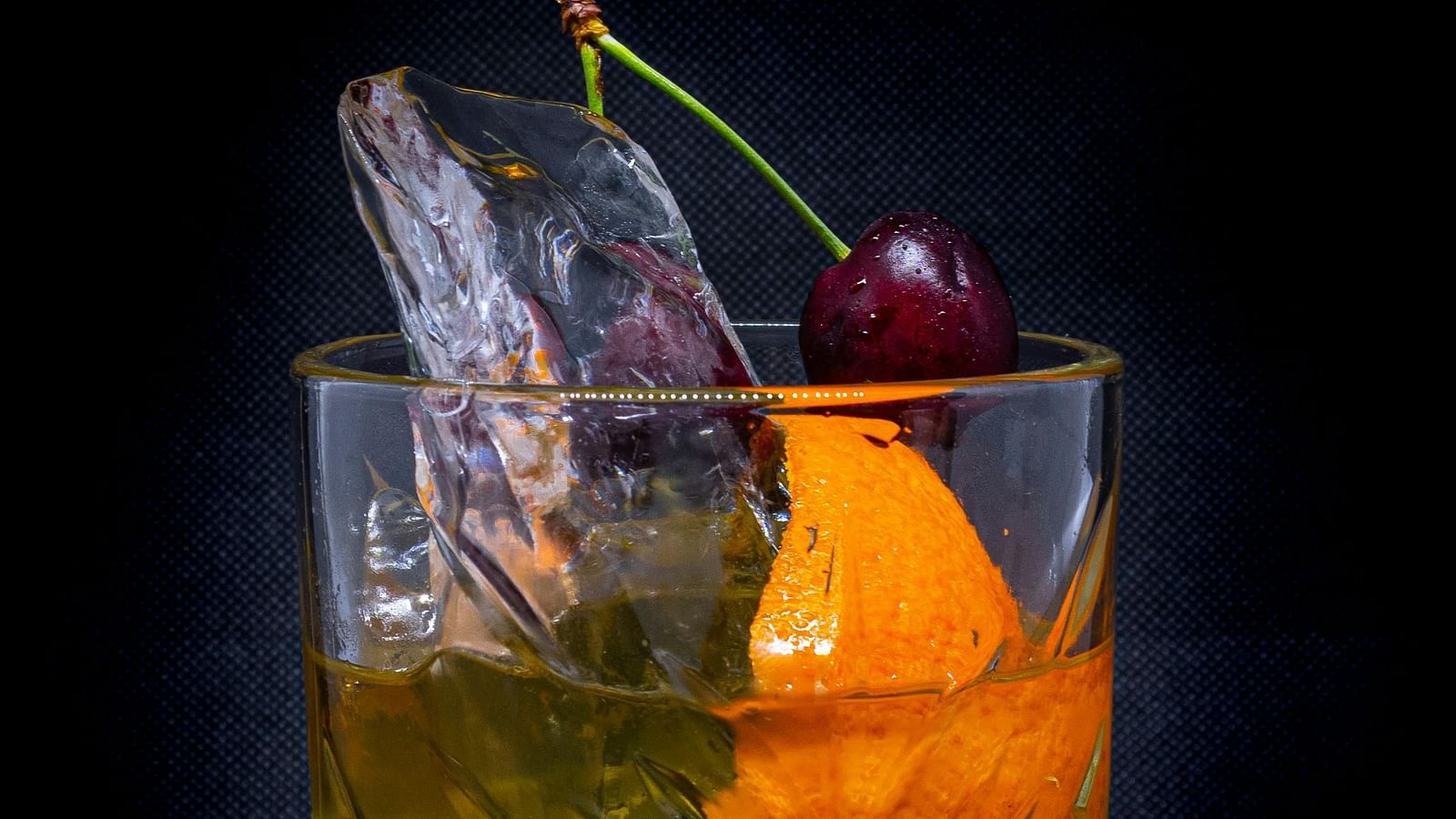 A cocktail served in a glass placed on the counter.