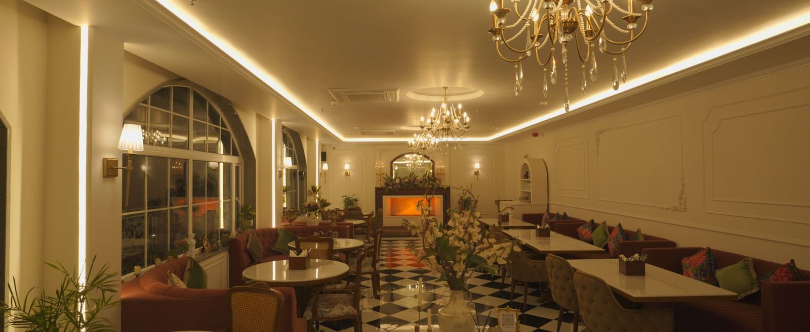 Wide-angle view of a grand dining space with elegant lighting and classic interiors - Mayfair Cafe & Suites, Dalhousie