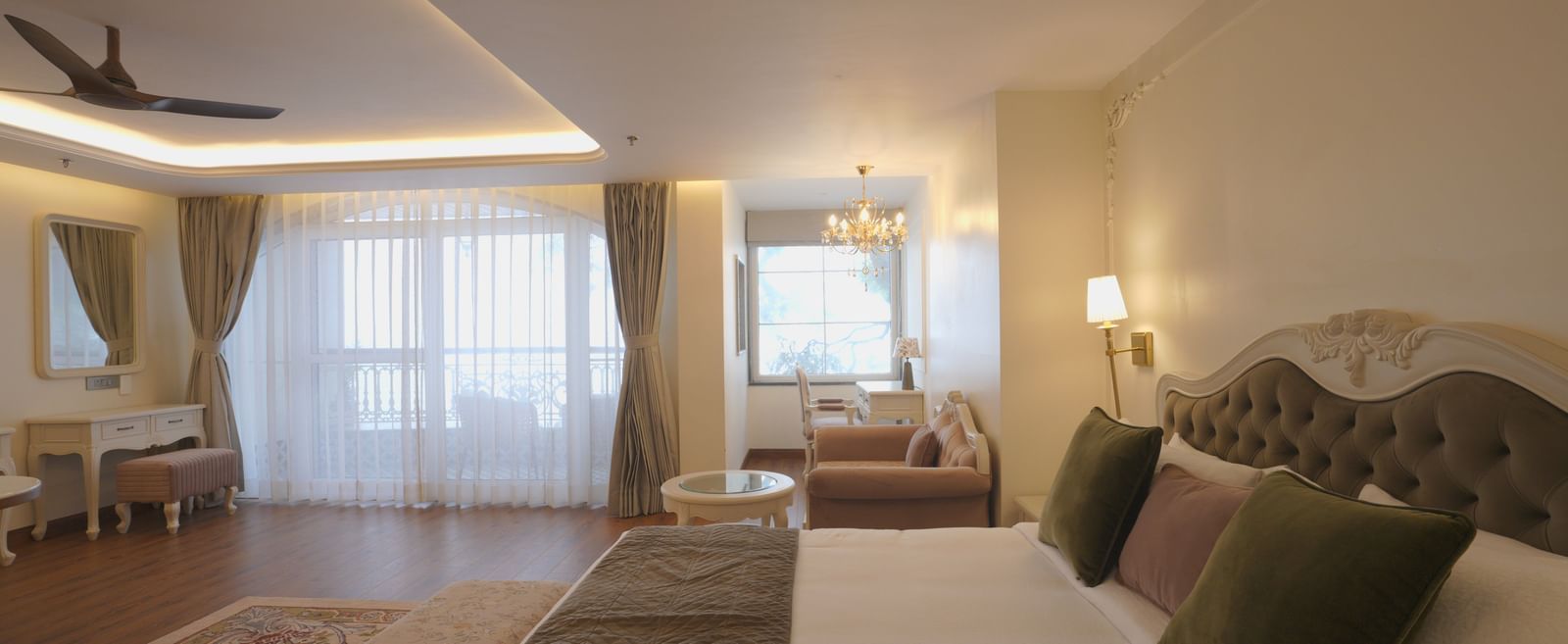 Premium bedroom featuring a plush bed, large windows, and subtle decor - Mayfair Cafe & Suites, Dalhousie