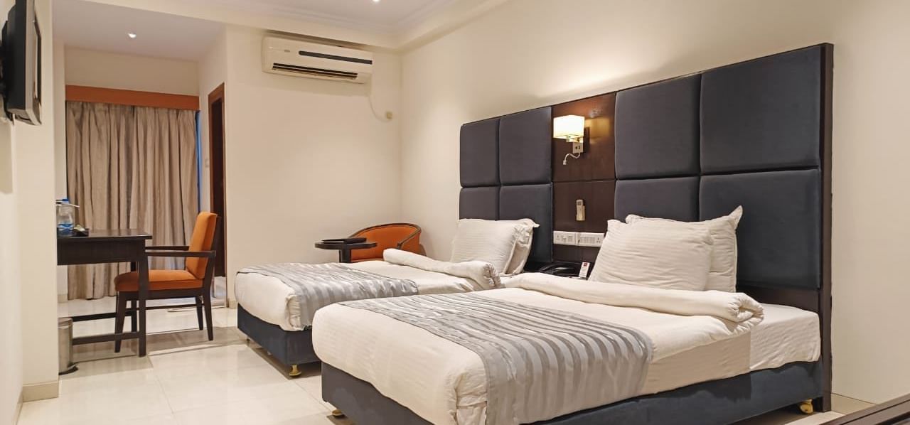 Spacious deluxe room at Lords Eco Inn Dahej featuring contemporary furnishings and soft lighting.