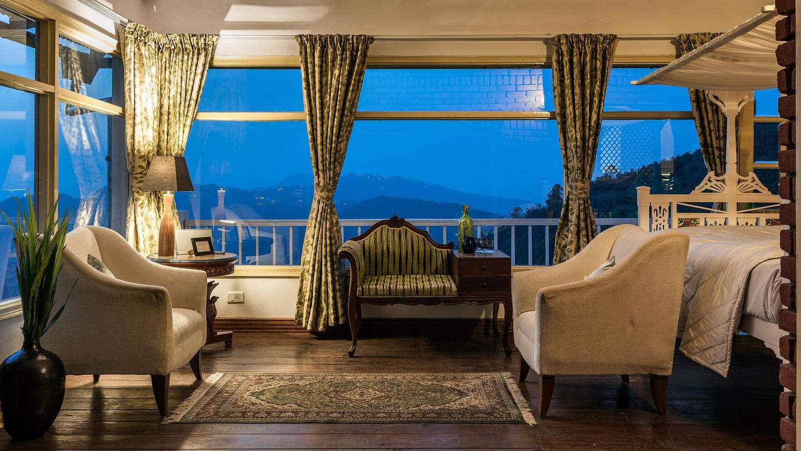 Sitting area with sofas and large window overlooking the mountains at Te Aroha by Shervani Mukteshwar