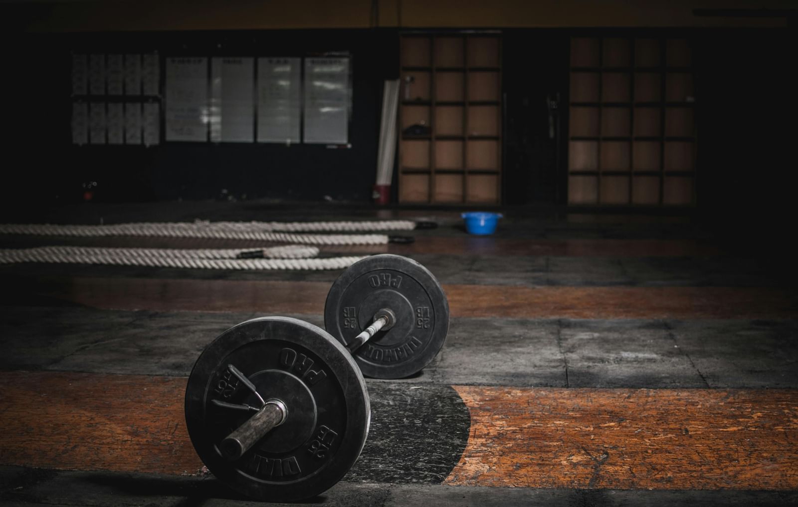 weightlifting barbell ready for a powerful workout in a dimly lit gym.