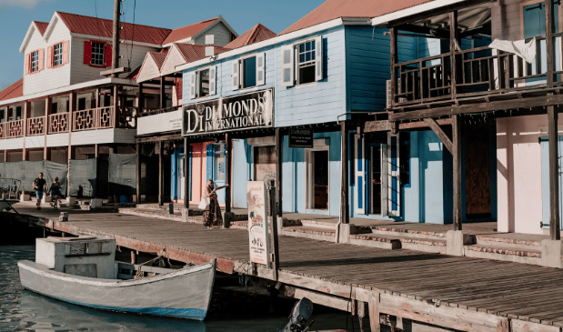 Colorful buildings line a waterfront with boats docked.