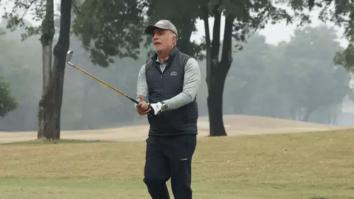 An image of golfer Arjun Sharma holding a golf stick in his hand in a golf course