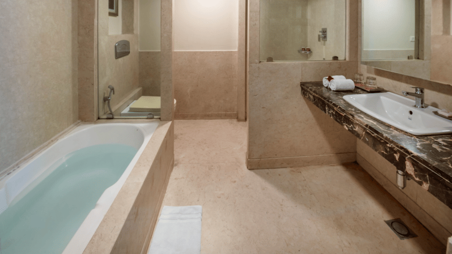 a bathroom at Libra Lords Inn Jaipur with a tub, single faucet with separate area for water closet and shower 