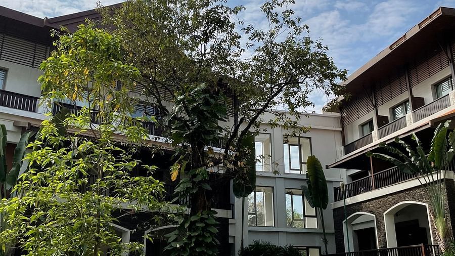 Buildings, green garden and a cloudy sky - Rhythm Lonavala