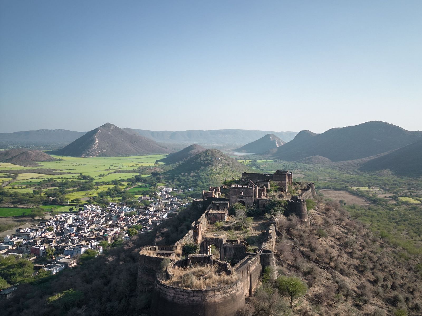 An aerial image of a Kankwari Fort with the backdrop of mountains - Utsav Camp Sariska.