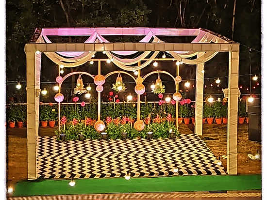 A decorated wedding mandap with lights.