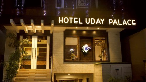 The illuminated entrance of Hotel Uday Palace, showcasing its modern facade as one of the popular hotels near Kashi Vishwanath Temple.