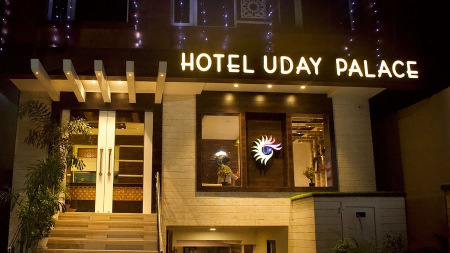 The entrance of Hotel Uday Palace with a signboard displaying the hotel’s name, illuminated by warm and welcoming lighting.