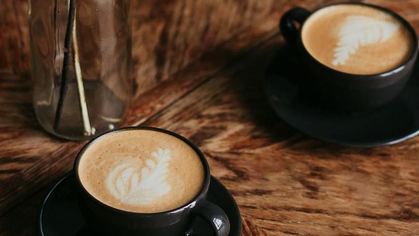 Image of two cups filled with coffee and a glass vase on the side - The Dukes Retreat, Khandala