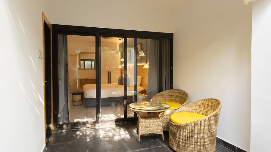 image of the private sit out area in the garden room along with huge french windows besides it - Darza Resorts