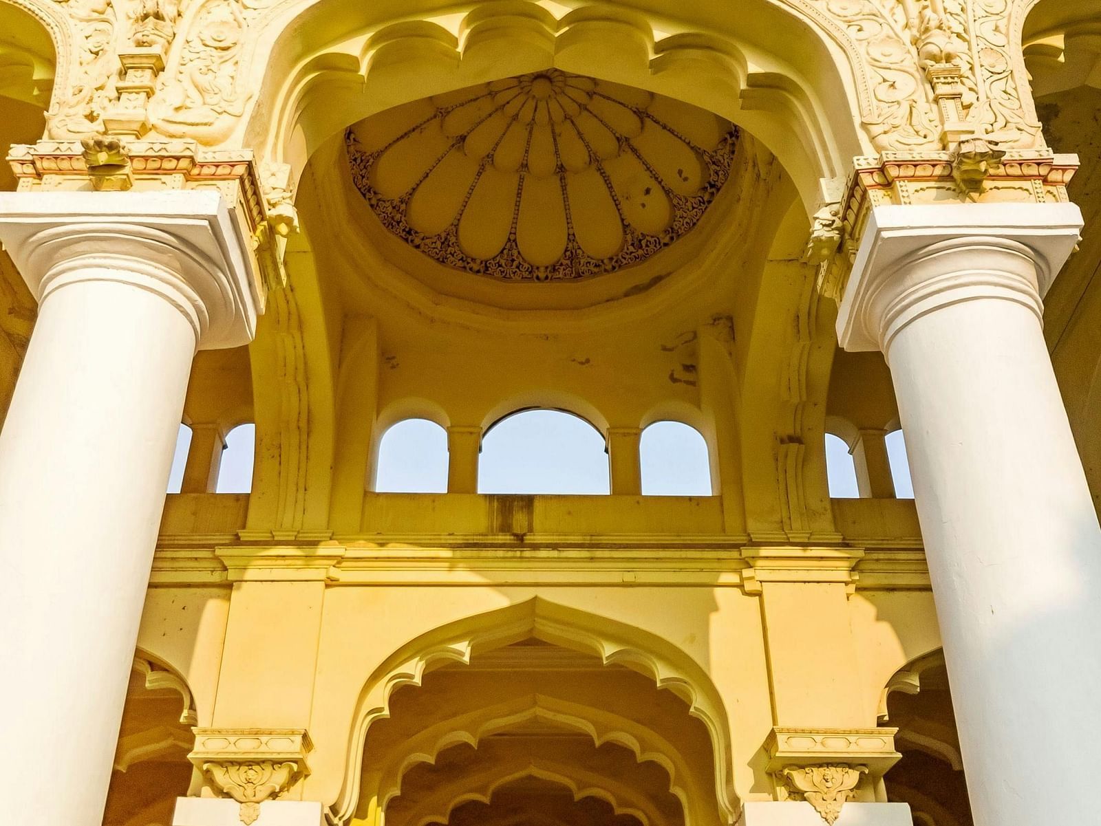 View of a holy place with pillars and carvings on the wall.