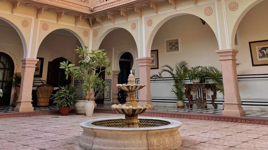 A courtyard featuring arched walkways and a central fountain under a clear blue sky - Khas Bagh, Jaipur