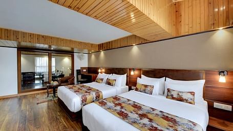 Image of suite with two beds and and a sitting area in the corner at Yashshree Mall Road, Darjeeling.