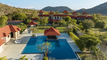 A small roofed structure placed in the middle of the outdoor swimming pool at Anandam Jungle Retreat Resort - one of the best Resort in Udaipur.
