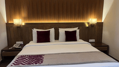 A well-lit, spacious bedroom with a comfortable king-sized bed - Marigold Sarovar Portico, Mashobra-Shimla