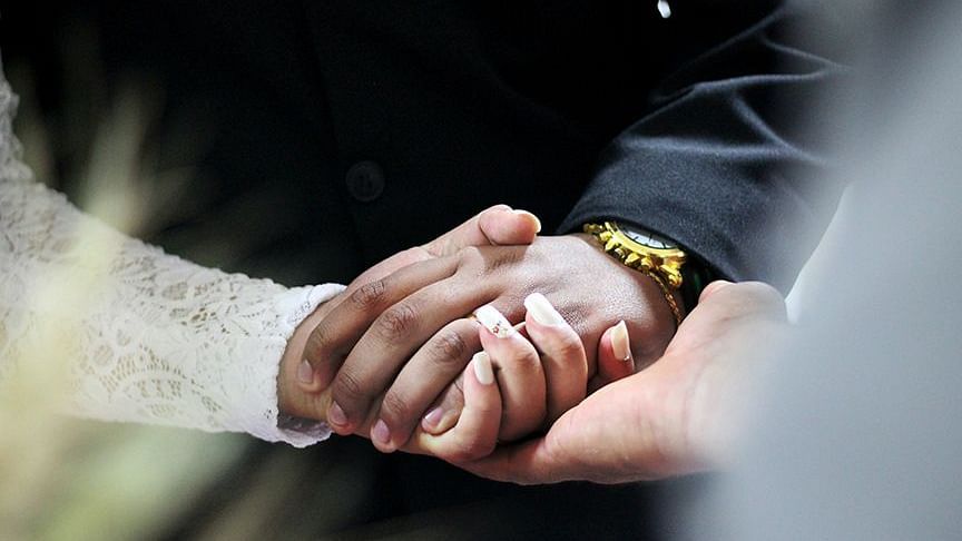 An image of a couple in bridal clothes holding hands - S Hotel Kingston, Jamaica