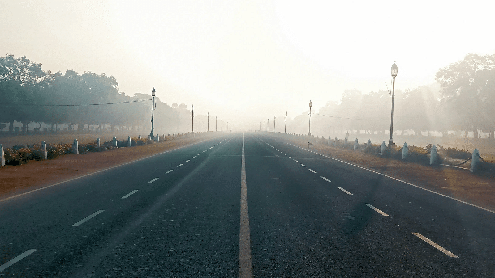 An overview of a road in Delhi with two lanes and mist covering in the background