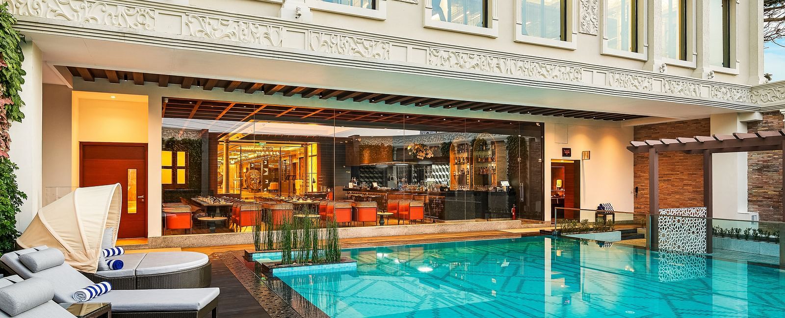 Outdoor pool area with seating and views of the hotel facade.