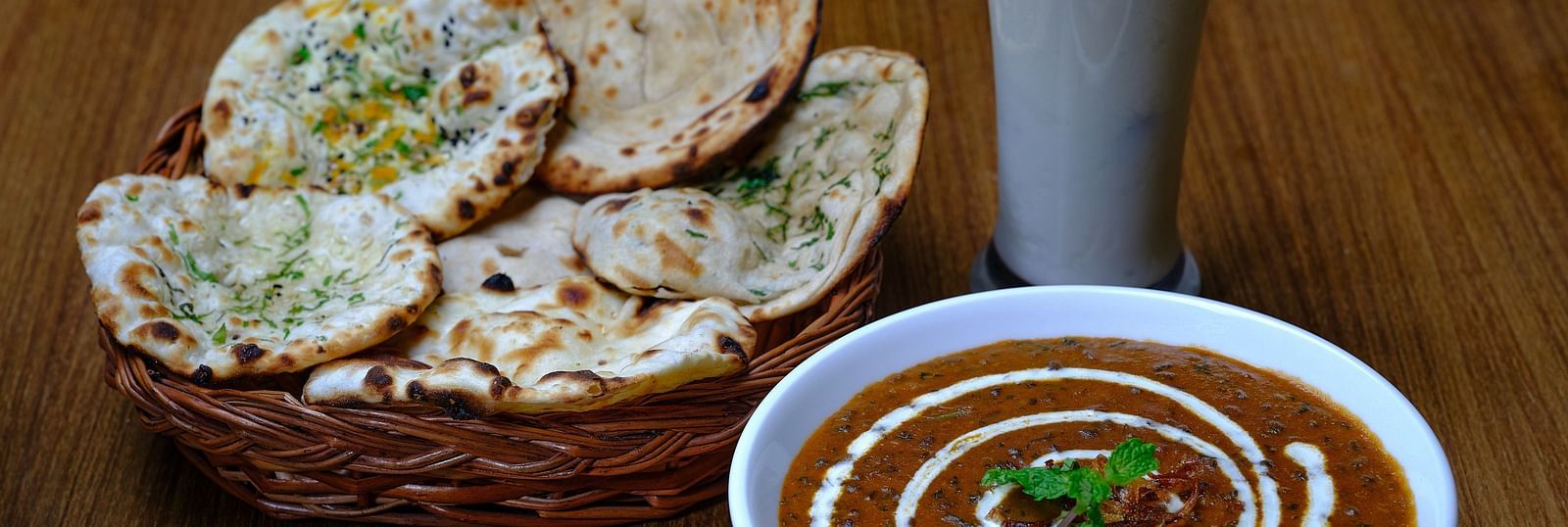 A bread basket served with a bowl of dal makhani at Essentia Premier Hotel, Chennai