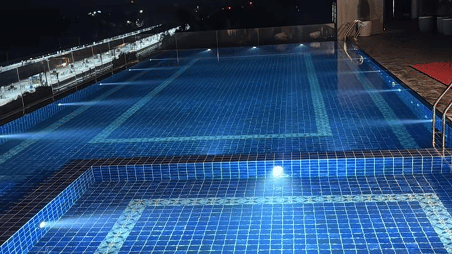 Rooftop swimming pool at Le ROI Digha Hotel, West Bengal, with seating and open views for guests to relax.