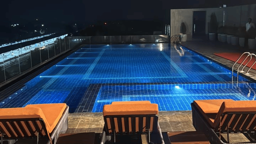 Swimming pool on the rooftop at Le ROI Digha Hotel, West Bengal, with seating and open views around the property.