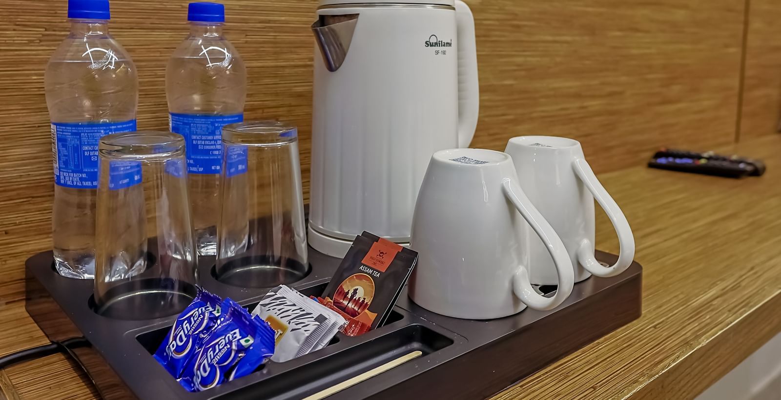 Tea and water setup with cups and snacks at Max Hotel Prayagraj.