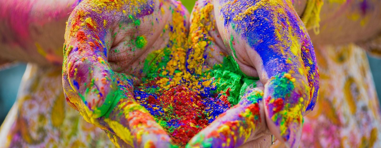 A person holding holi colours in their hand