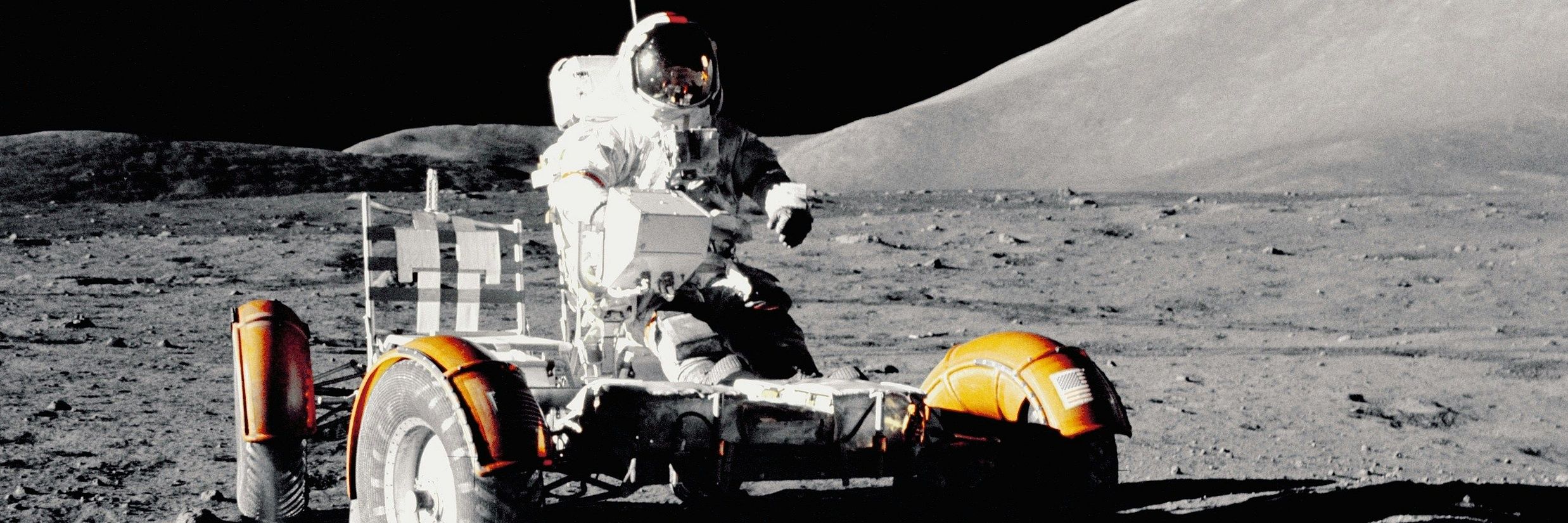 a person atop a machine on the surface of an outer planet