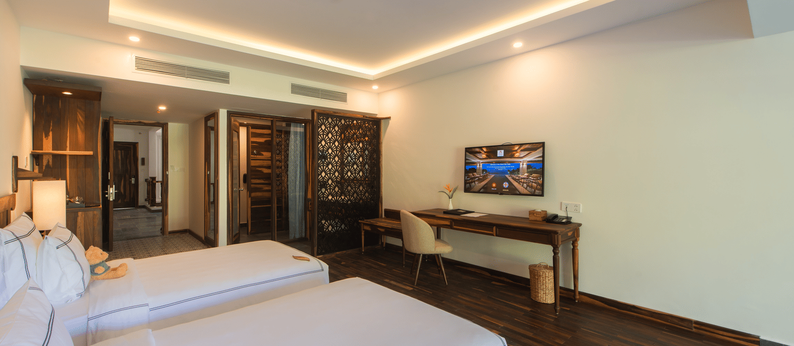 Balcony Room at Alibu Resort Nha Trang with lounge area, television, twin bed, and wooden decor.