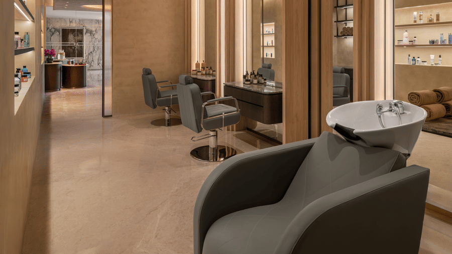 Salon area with styling chairs, mirrors and a wash basin station at The Residency Signature Madurai.