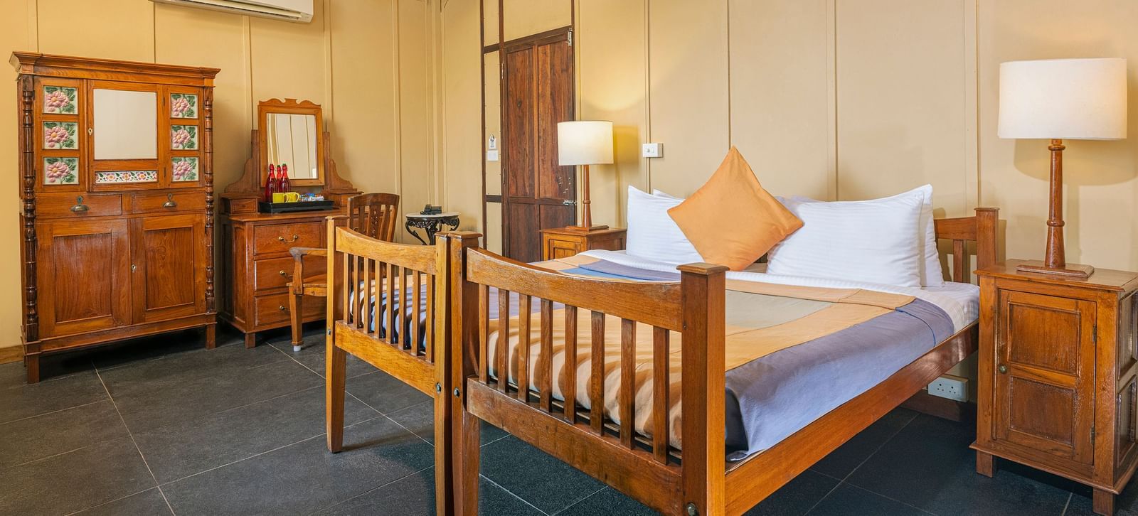 A double bed with side tables and lamps inside a Superior room | Mango Hill, Pondicherry