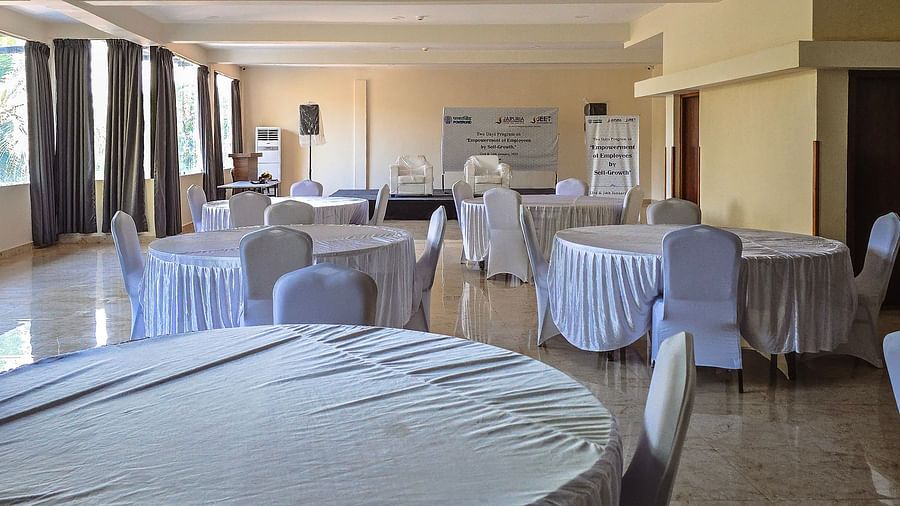 Event space set up with white-covered round tables and natural lighting at The Verda de Miranda Resort.