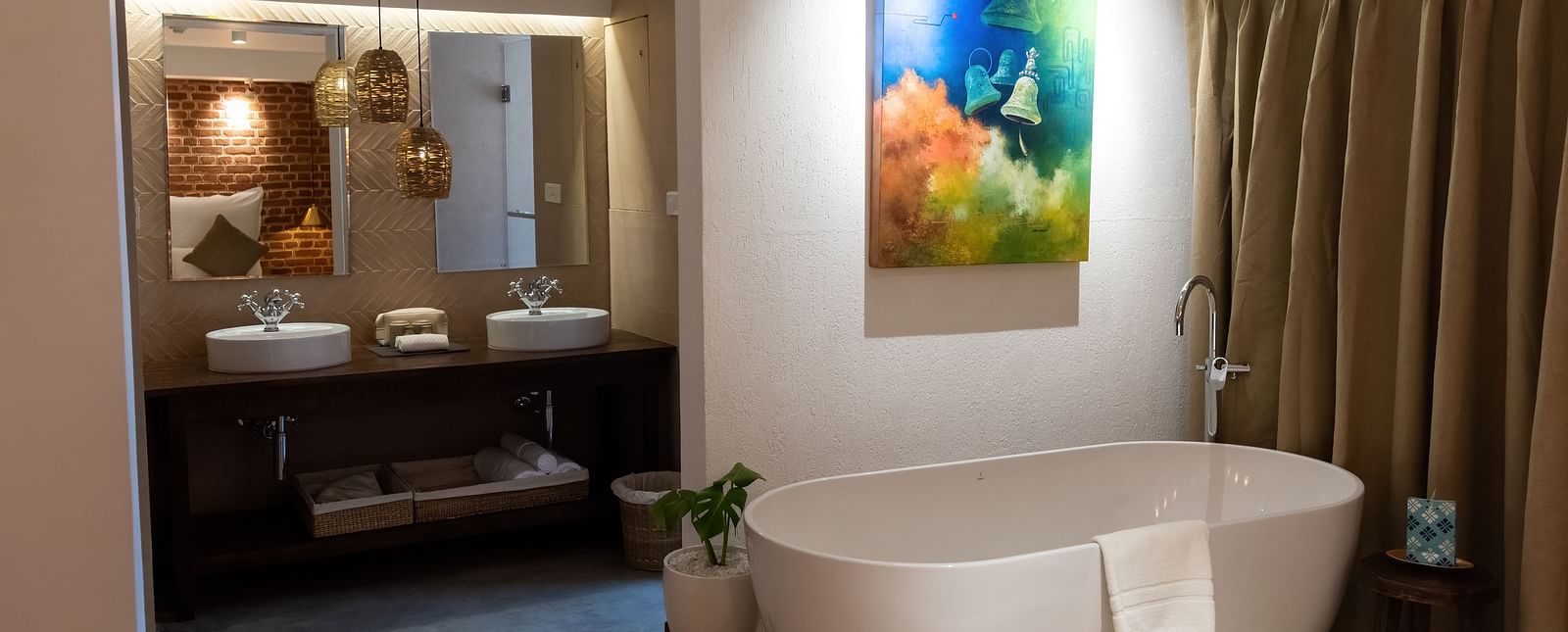 Bathtub, wall hanging and the washroom area at the Nepali Suite - The Nanee