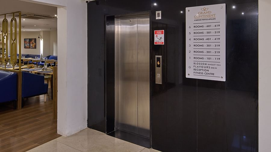 Elevator area with polished black walls and signage - Grand Continent, Brookefield