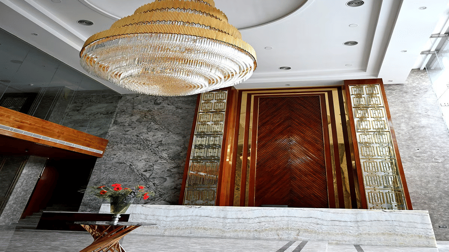 A wide-angle shot of the reception at the Leroy Grand, Yeshwanthpur, with a huge chandelier hanging from the ceiling.