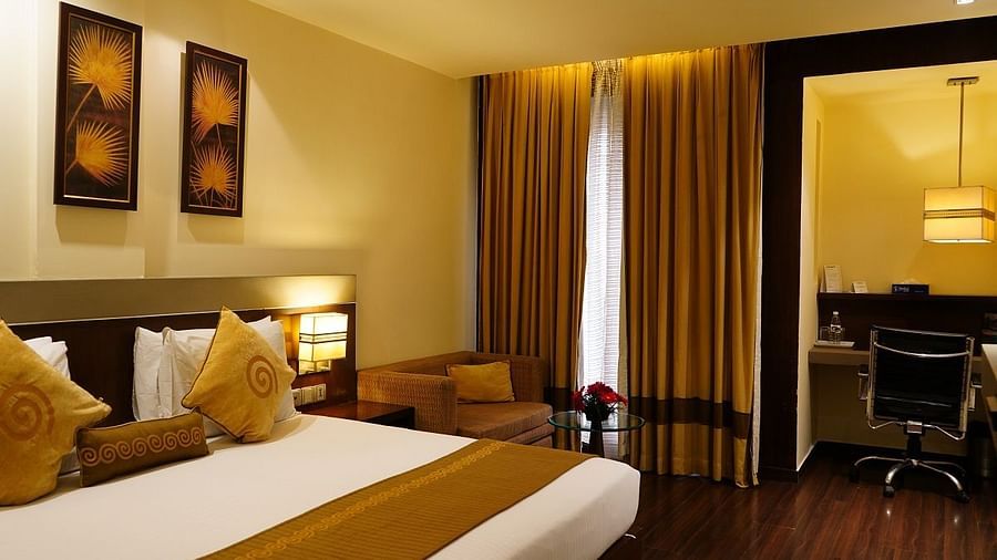 Club Room featuring a cosy bed and work desk at Shervani Nehru Place, New Delhi